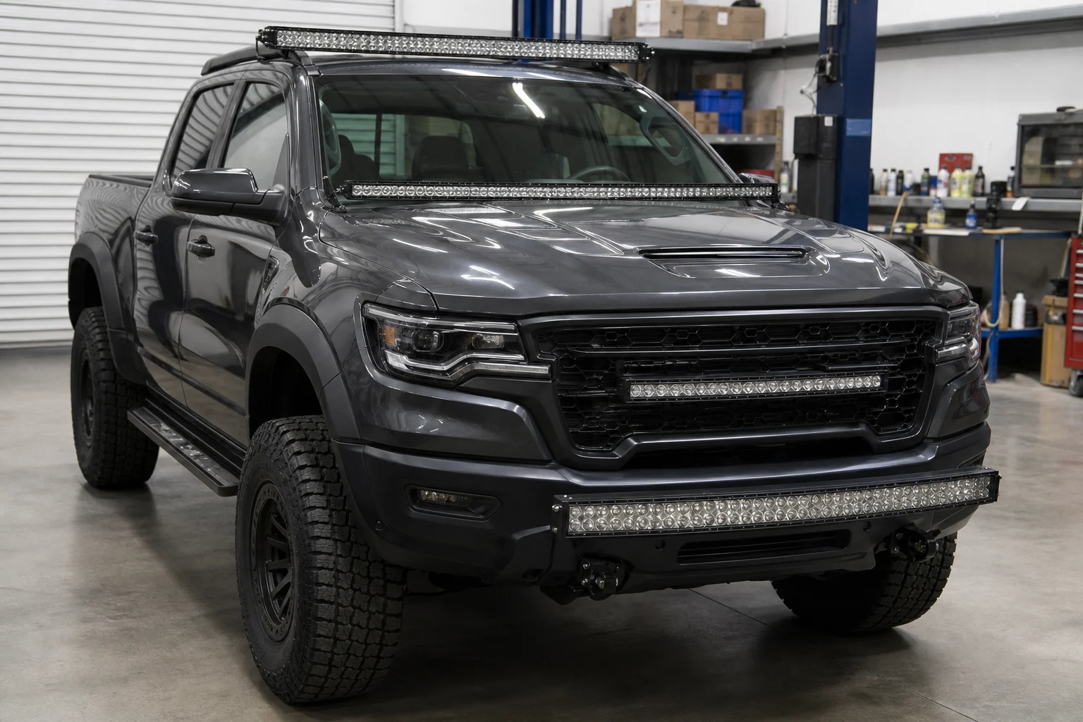 Off-road pickup truck with a curved LED light bar test fitted on roof, windshield, bumper, and grille positions in a workshop
