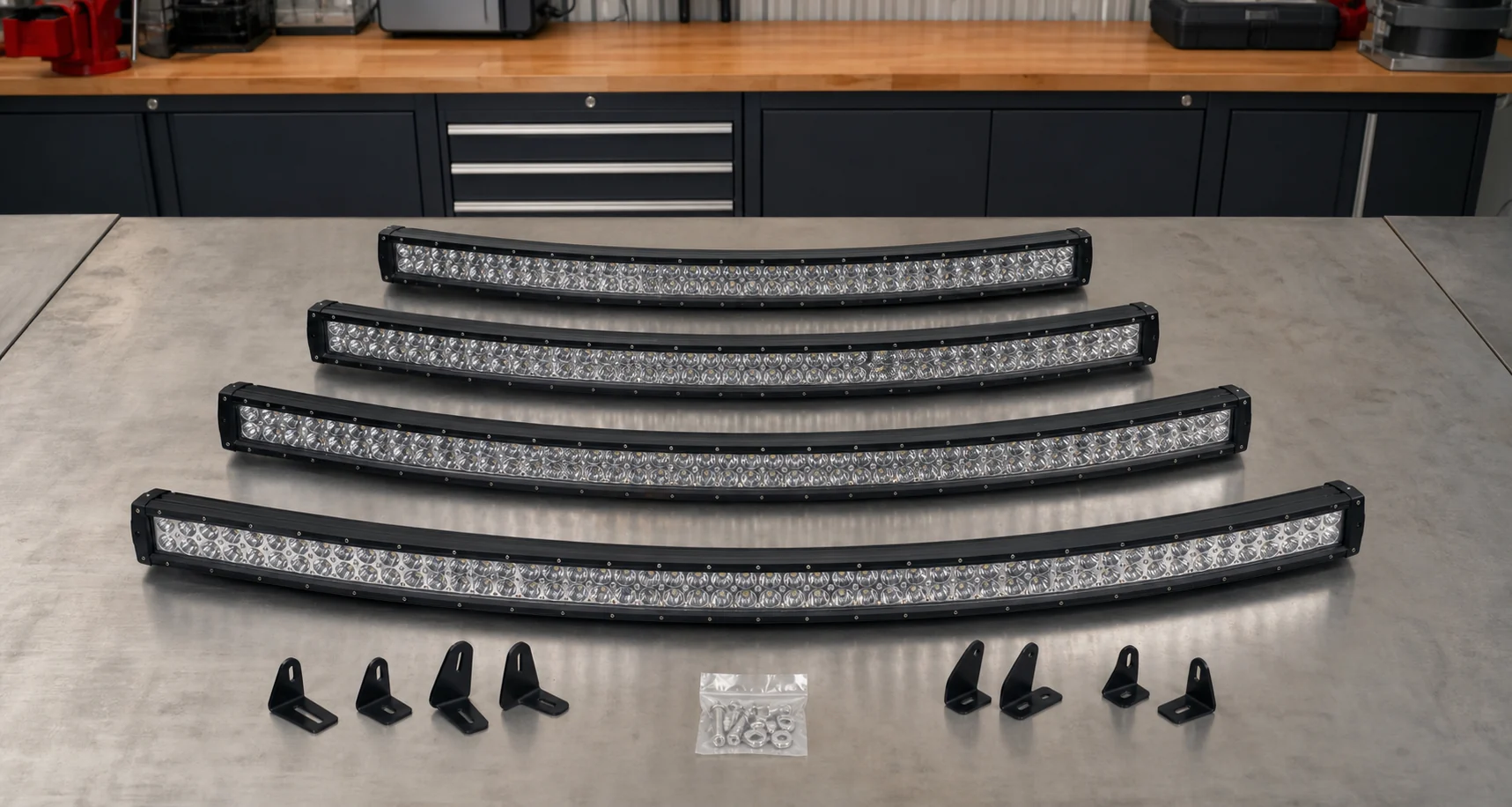 Product lineup of 20 inch, 30 inch, 40 inch, and 50 inch curved LED light bars displayed on a workshop table