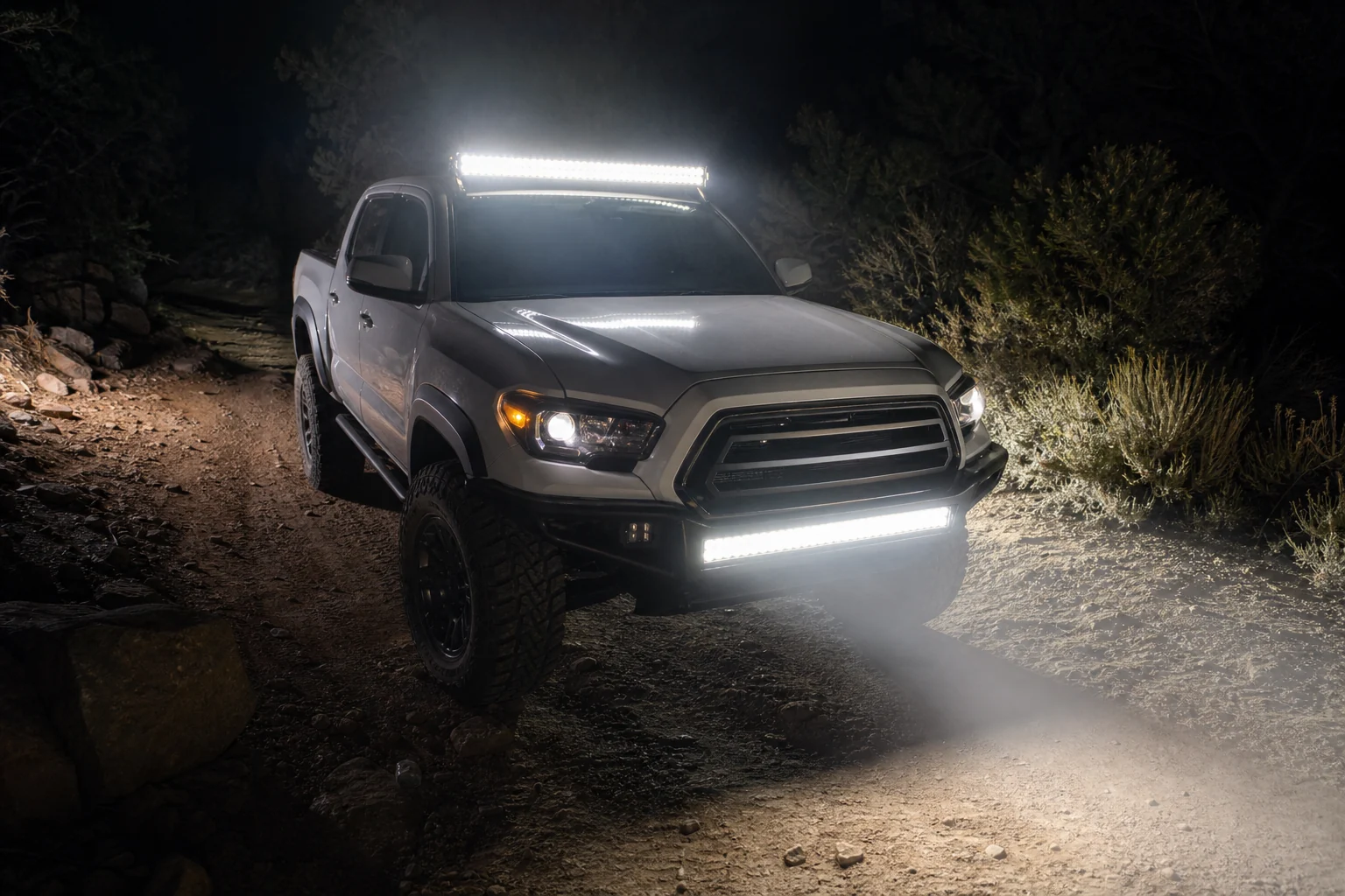 Pickup truck showing roof and bumper LED light bar mounting positions with visible hood glare