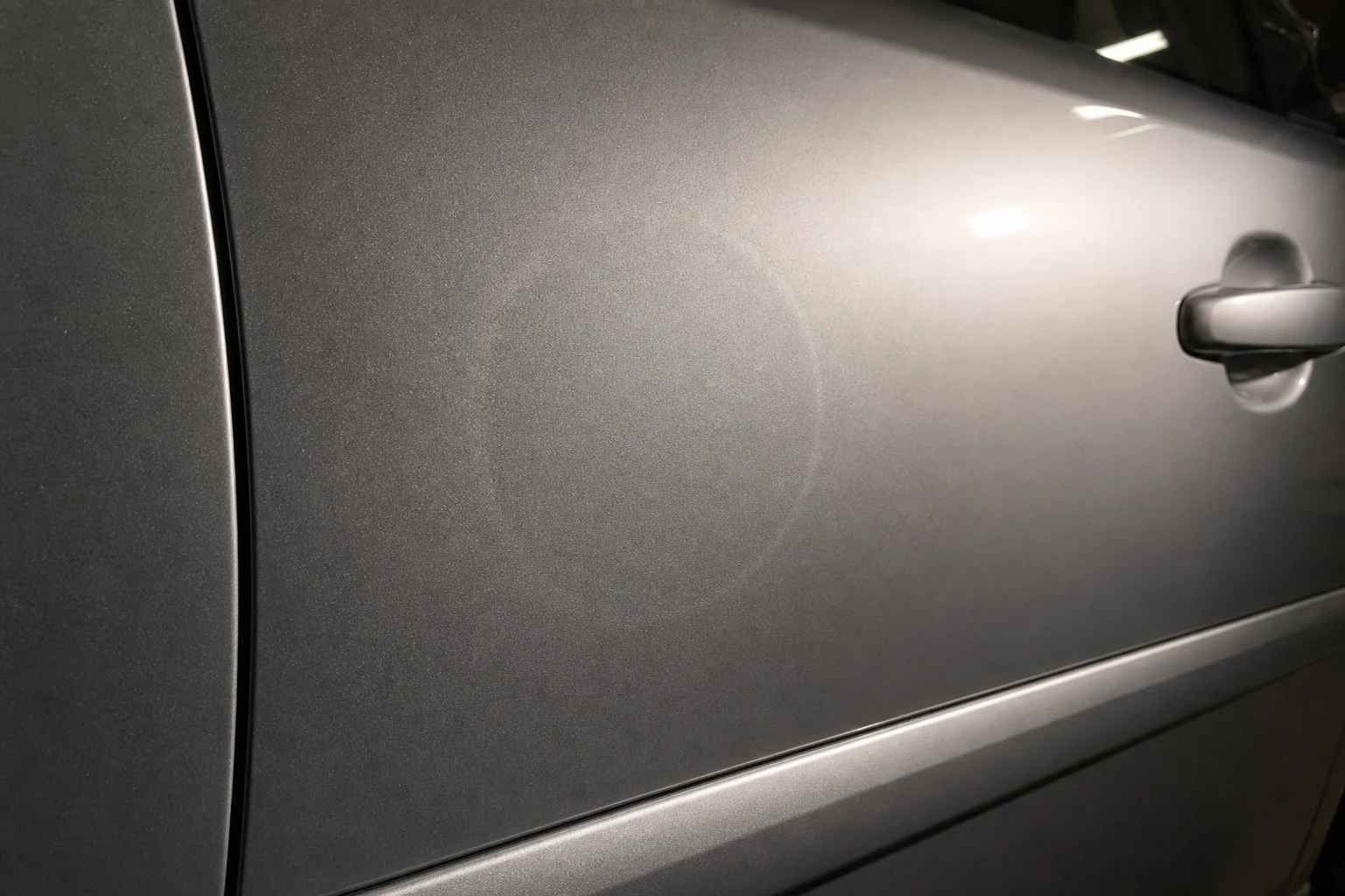 What is Feathering in Auto Body Work? How to Feather Sand Paint Edges 6 Silver car door with a circular mapping line visible under low-angle inspection light after painting
