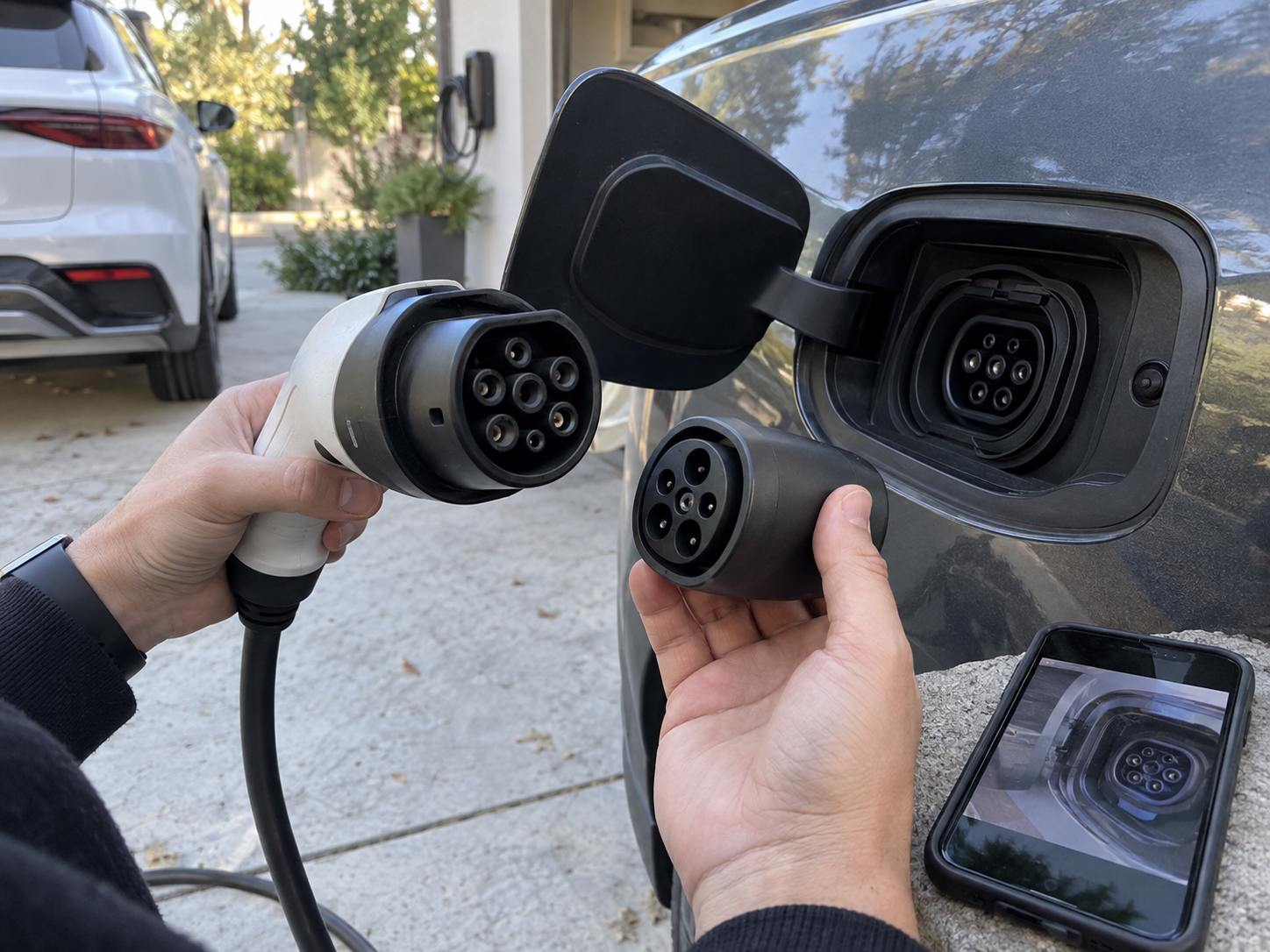 EV Charging Accessories Compatibility Checklist: Vehicle, Connector, and Market Fit 1 Hands comparing unbranded EV charging connectors and an adapter beside a vehicle inlet during a fitment check
