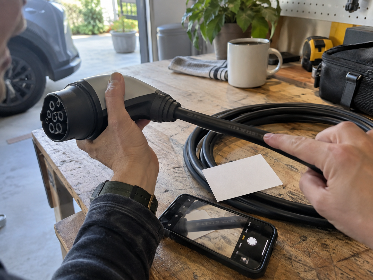EV Charging Cable Markings Explained: How to Read Ratings, Labels, and Datasheets 1 Hands tracing an EV charging cable marking beside its connector