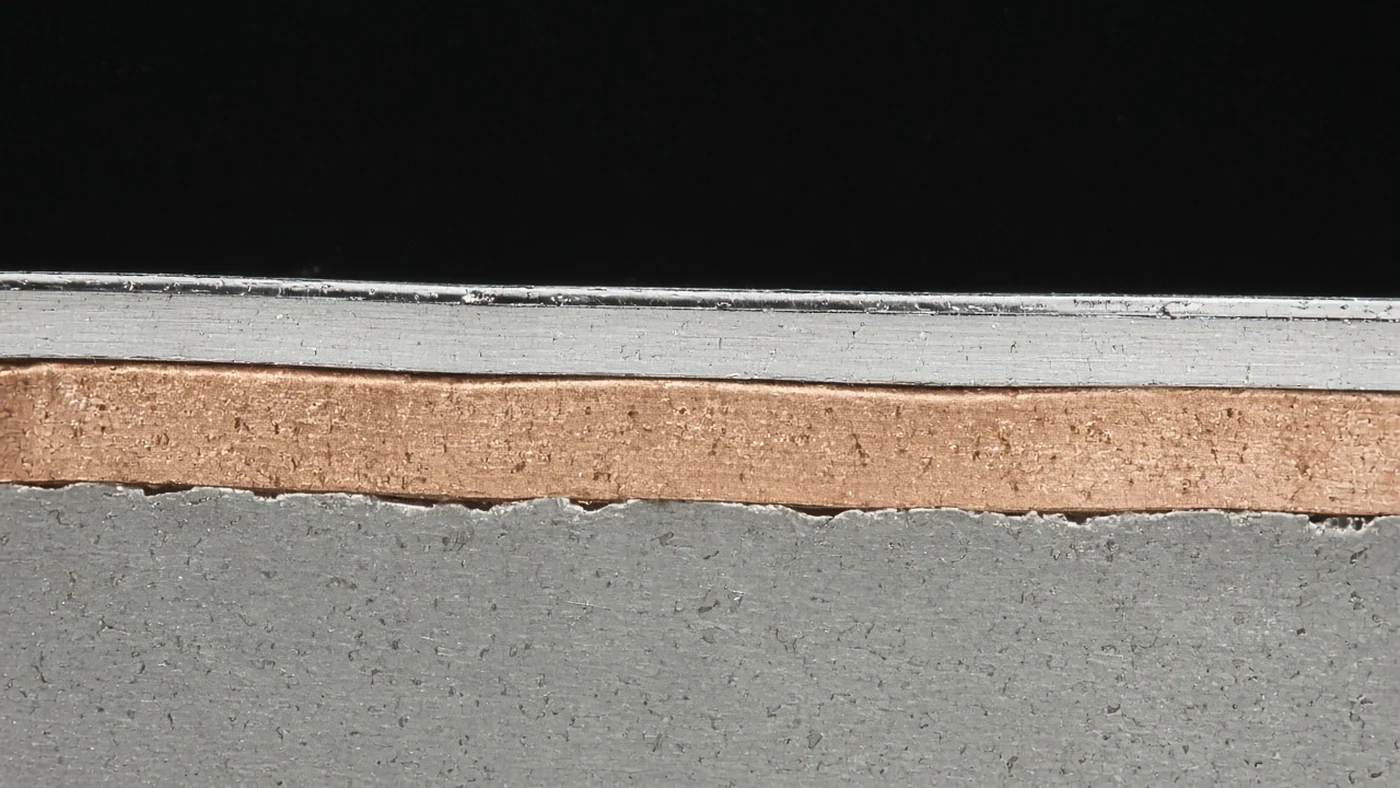 Cross-section of chrome plating on ABS showing copper, nickel and chrome layers
