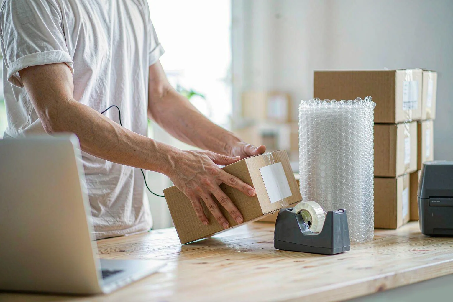 Solutions 3 Online seller packing an auto accessory carton at a desk