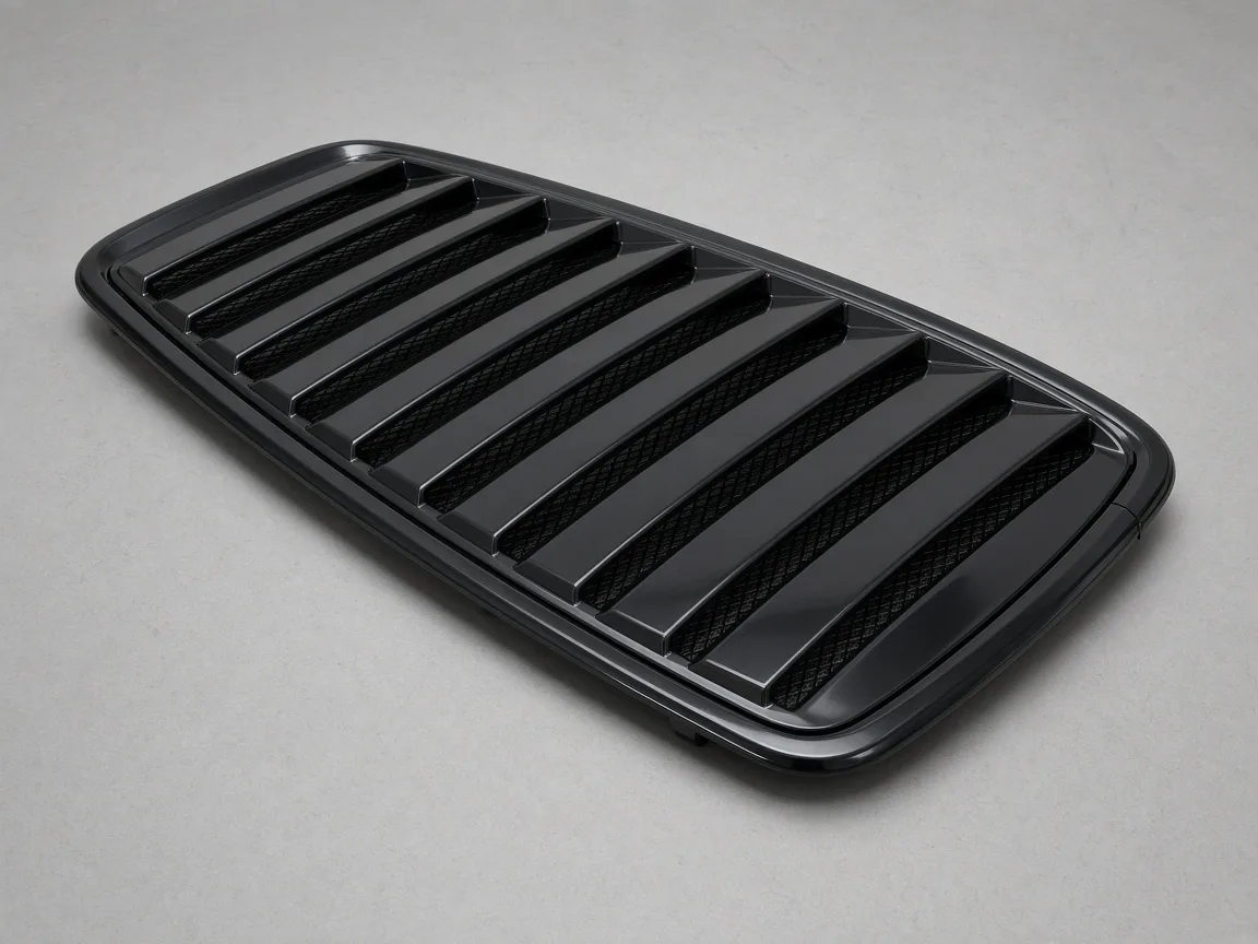 Gloss black vehicle-specific rear window louver on an inspection table