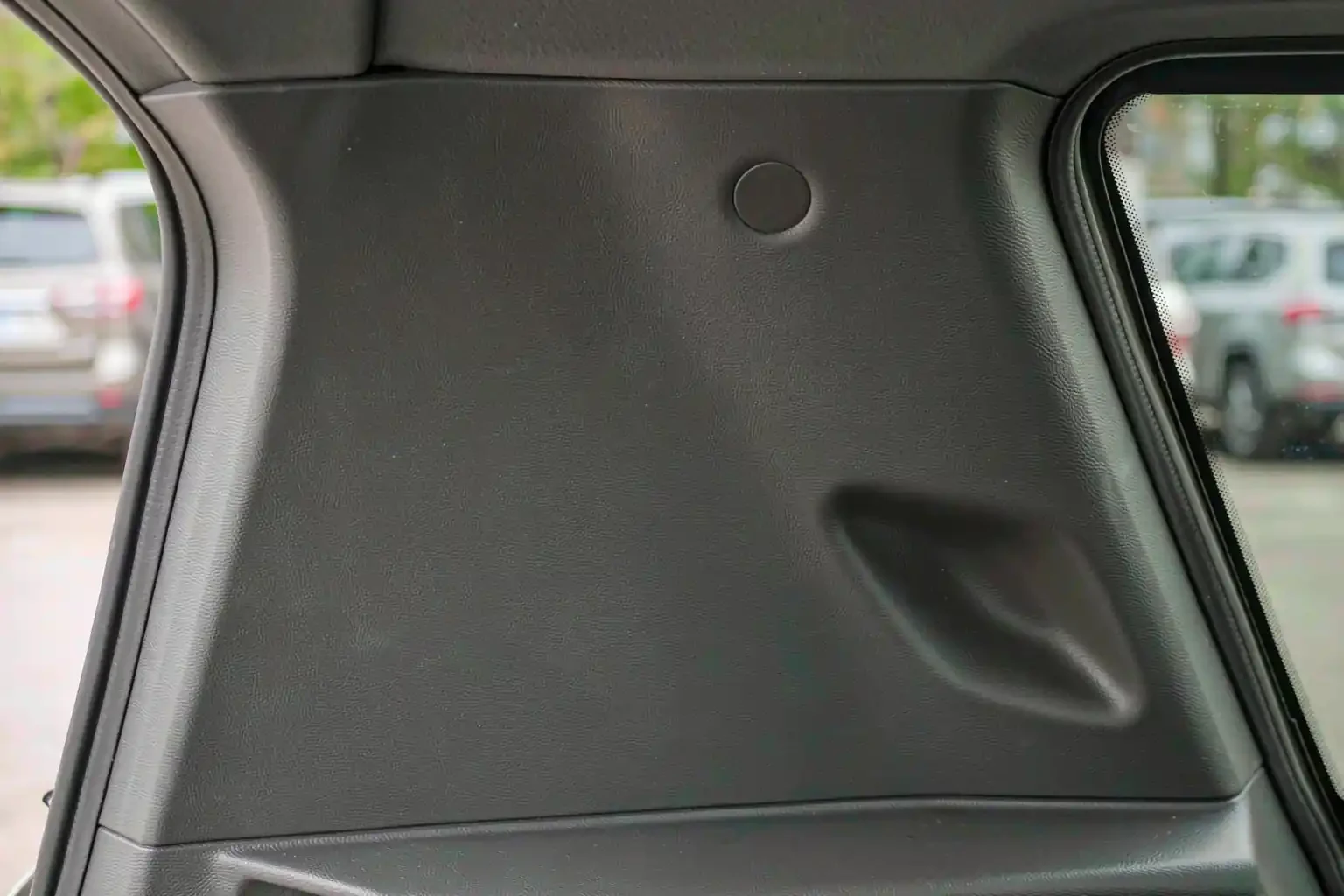 Grain-textured molded plastic pillar trim panel