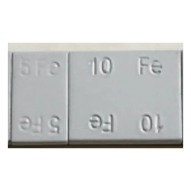 Close-up of rectangular grey coated Fe5 and Fe10 steel wheel weight segments