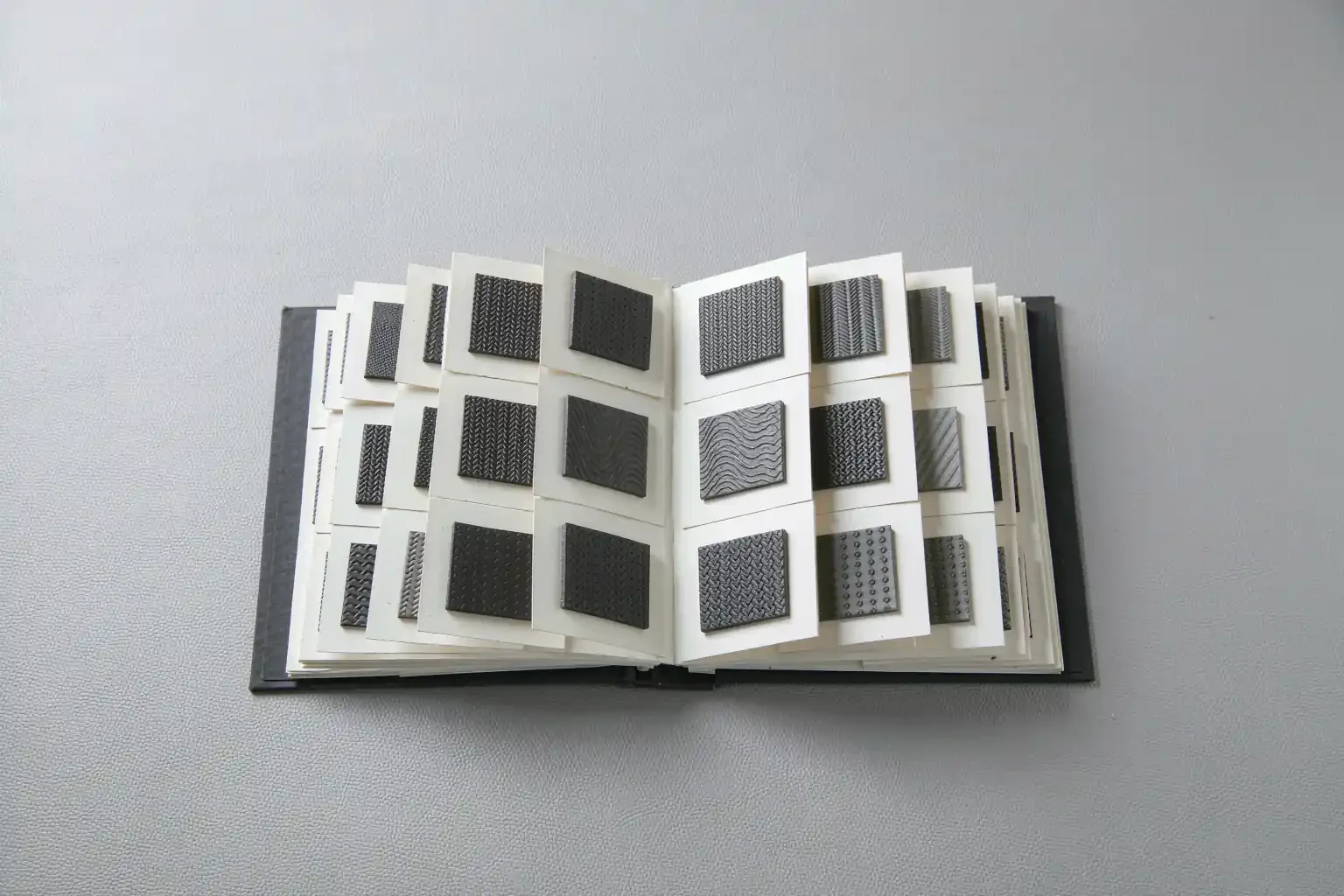 Open mold texture sample book with grain swatches