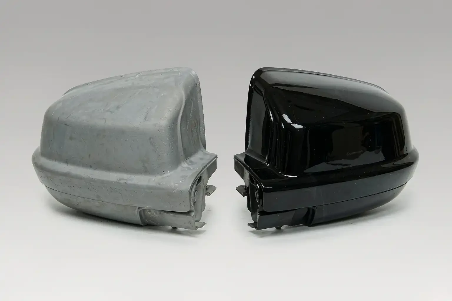 PP Plastic & TPO for Car Bumpers and Exterior Parts 4 Mirror cap in grey primer next to the same cap painted gloss black