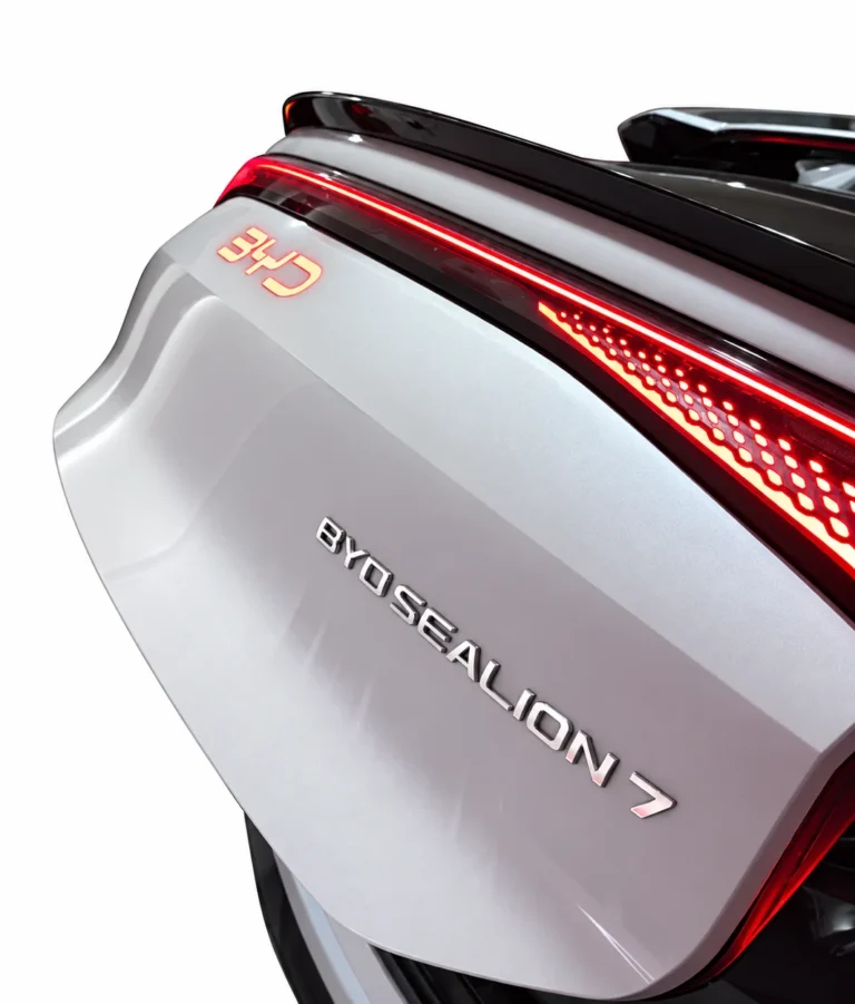 Illuminated BYD Sealion 7 rear emblem light installed on vehicle, white background
