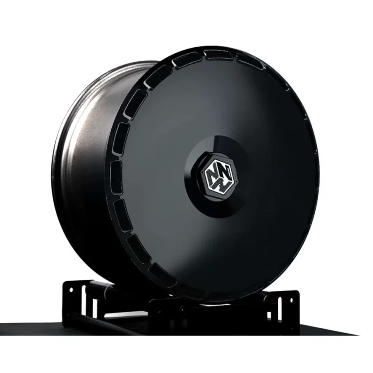 Black cyber wheel cover for Tesla on a rim stand