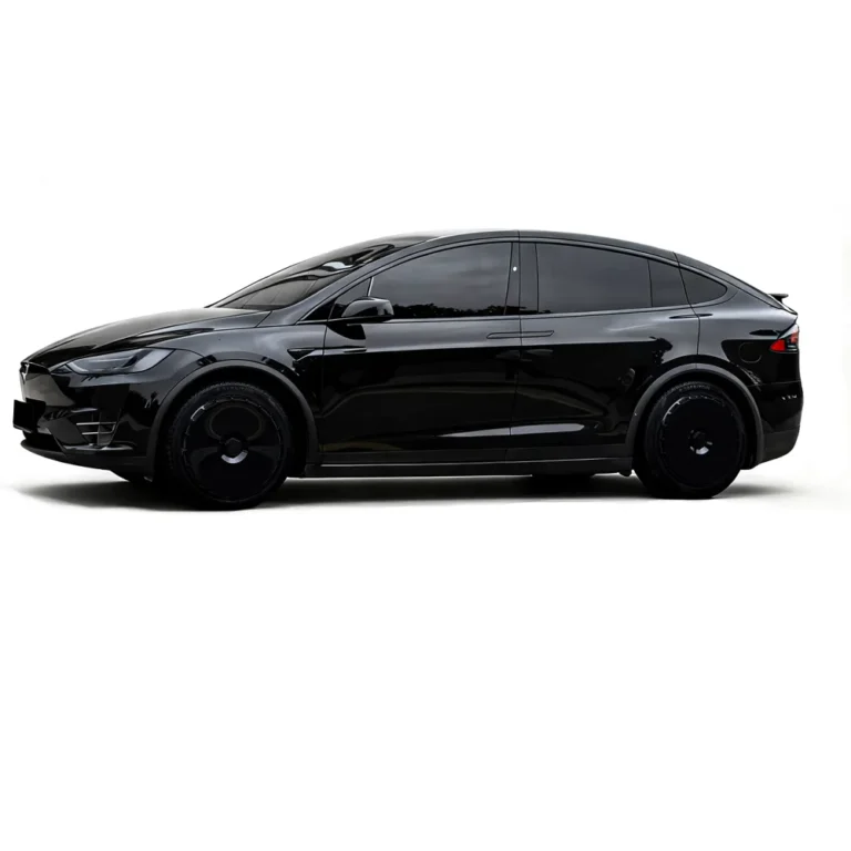 Black Tesla fitted with cyber-style wheel covers, side view