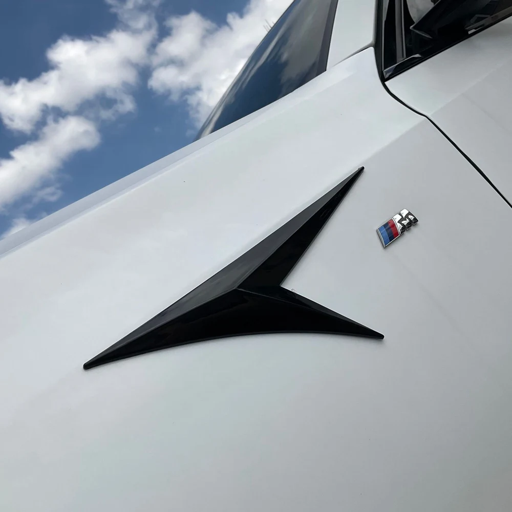 Best 11 Easy Exterior Car Mods for Detailing & Tuning Shops 10 Gloss black side emblem trim installed on the front fender of a white car