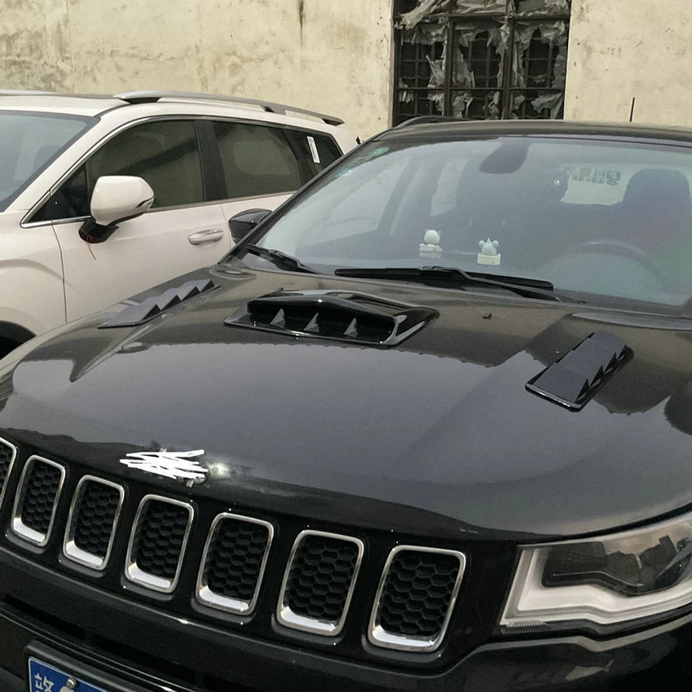 Side view of gloss black hood scoop and side vents installed on a black SUV