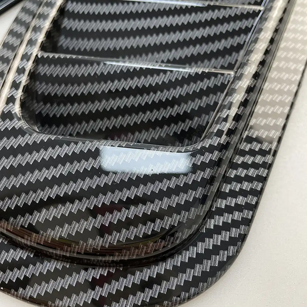 Close-up of carbon fibre pattern texture on the hood vent louver