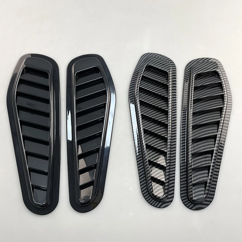 Gloss black and carbon black hood vent louver pairs side by side