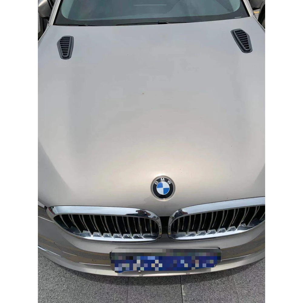 Black decorative hood vents installed on a silver car bonnet