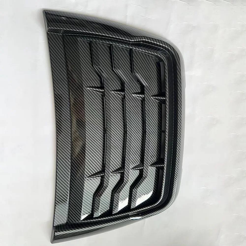 Carbon fibre black louvered hood vent close-up