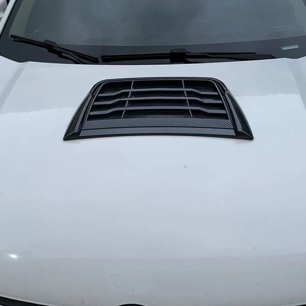 Black louvered hood scoop installed on a white bonnet