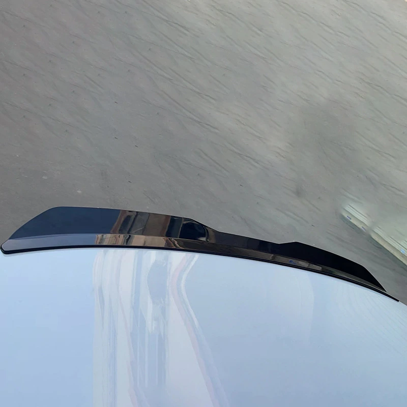 Will a Universal Spoiler Fit Your Car? A Rear Spoiler Fitment Guide 1 Gloss black universal rear hatch spoiler positioned along a white vehicle panel
