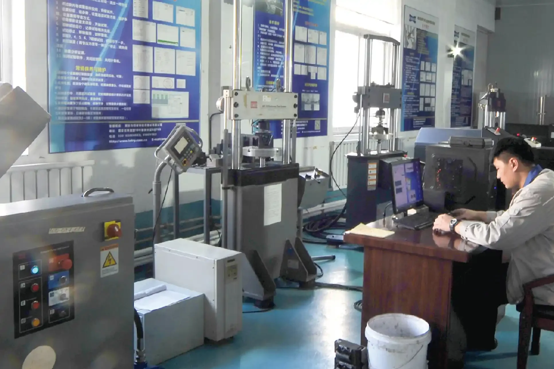 Technician at a universal testing machine in the Yirox testing lab
